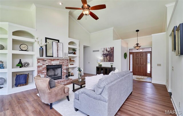 5 Tucker Manor Ct, Wentzville, MO 63385 - living area with ceiling fan, a fireplace, wood finished floors, built in shelves, and high vaulted ceiling