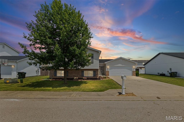 412 Audry Dr, Dupo, IL 62239 - view of front of house with driveway, a lawn, brick siding, and a garage