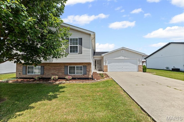 412 Audry Dr, Dupo, IL 62239 - tri-level home with brick siding, an attached garage, driveway, and a front lawn
