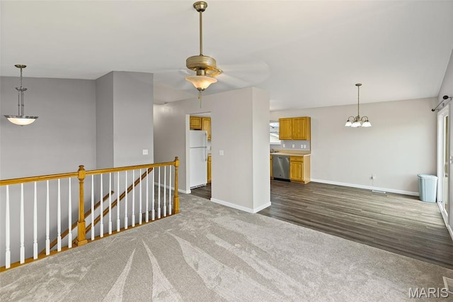 412 Audry Dr, Dupo, IL 62239 - empty room with a ceiling fan, dark colored carpet, dark wood-style flooring, and a chandelier