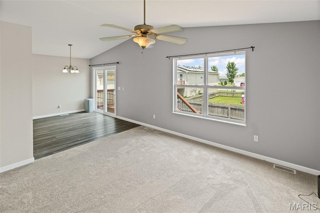 412 Audry Dr, Dupo, IL 62239 - carpeted empty room featuring vaulted ceiling, ceiling fan, a chandelier, and wood finished floors