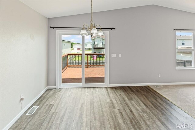 412 Audry Dr, Dupo, IL 62239 - unfurnished dining area with lofted ceiling, wood finished floors, healthy amount of natural light, and a chandelier