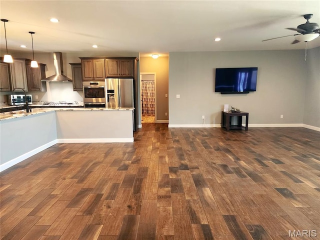 9339 Prairie Ridge Rd, Walsh, IL 62297 - kitchen with wall chimney range hood, appliances with stainless steel finishes, open floor plan, a ceiling fan, and dark wood finished floors