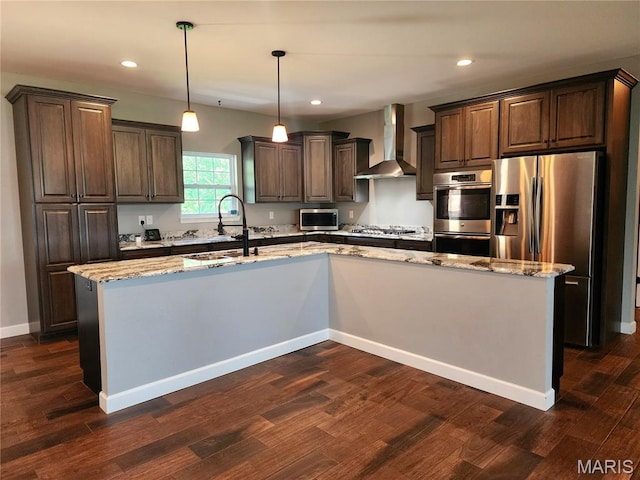 9339 Prairie Ridge Rd, Walsh, IL 62297 - kitchen featuring wall chimney range hood, appliances with stainless steel finishes, dark brown cabinets, light stone counters, and a spacious island