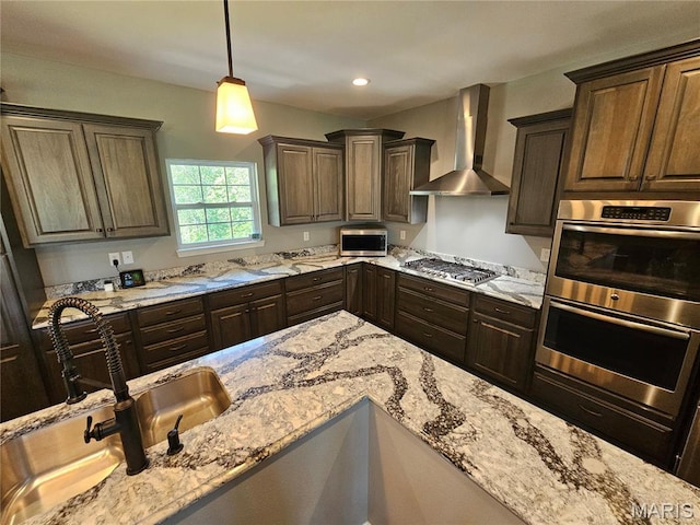 9339 Prairie Ridge Rd, Walsh, IL 62297 - kitchen featuring wall chimney range hood, stainless steel appliances, light stone countertops, dark brown cabinetry, and recessed lighting