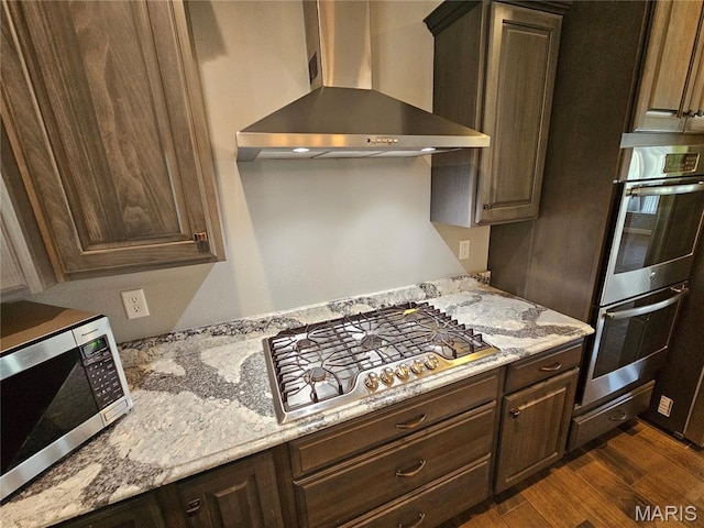 9339 Prairie Ridge Rd, Walsh, IL 62297 - kitchen with wall chimney range hood, appliances with stainless steel finishes, dark wood finished floors, and dark brown cabinets
