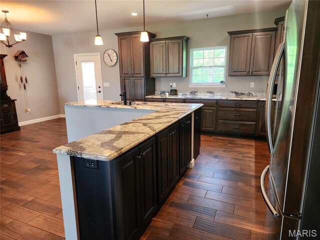 9339 Prairie Ridge Rd, Walsh, IL 62297 - kitchen featuring freestanding refrigerator, dark wood-style floors, a center island with sink, recessed lighting, and light stone counters