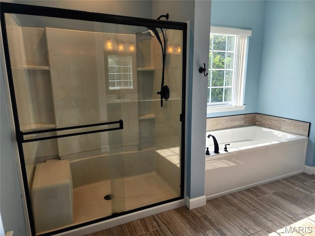 9339 Prairie Ridge Rd, Walsh, IL 62297 - bathroom with a garden tub, a stall shower, and wood finished floors