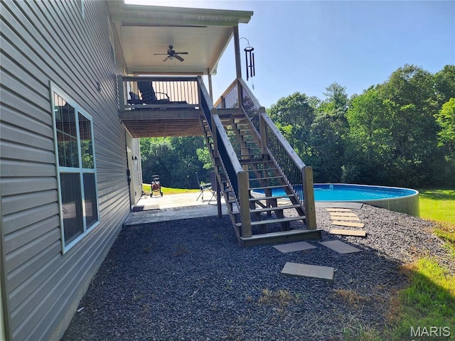 9339 Prairie Ridge Rd, Walsh, IL 62297 - view of playground with a patio area, stairway, a ceiling fan, and an outdoor pool