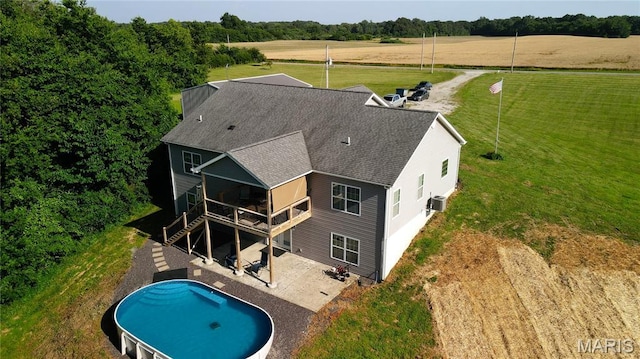 9339 Prairie Ridge Rd, Walsh, IL 62297 - rear view of property with a shingled roof, a patio area, a yard, an outdoor pool, and a deck