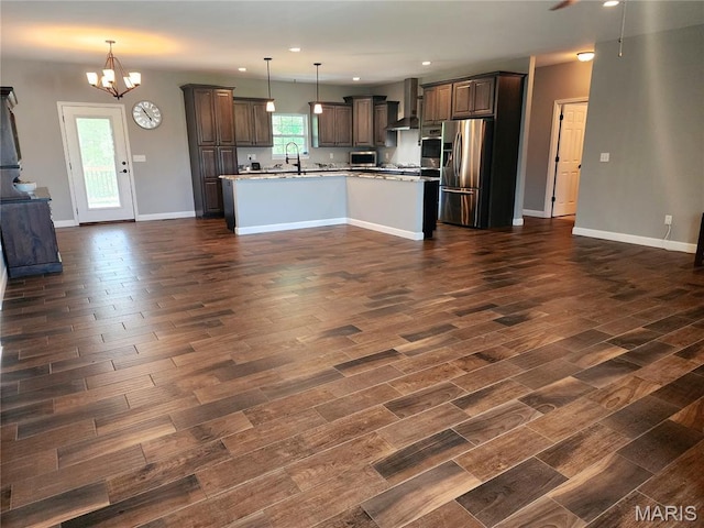 9339 Prairie Ridge Rd, Walsh, IL 62297 - kitchen featuring appliances with stainless steel finishes, wall chimney range hood, open floor plan, recessed lighting, and a chandelier