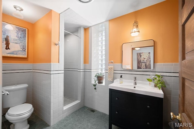 6505 Michigan Ave, Saint Louis, MO 63111 - full bath featuring tile walls, tile patterned flooring, tiled shower, vanity, and a wainscoted wall