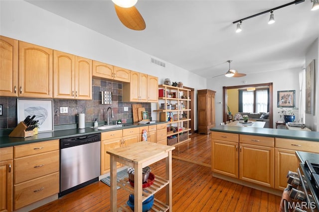 6505 Michigan Ave, Saint Louis, MO 63111 - kitchen featuring appliances with stainless steel finishes, a ceiling fan, dark countertops, and backsplash