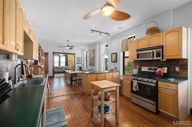 6505 Michigan Ave, Saint Louis, MO 63111 - kitchen featuring appliances with stainless steel finishes, ceiling fan, dark wood finished floors, and dark countertops