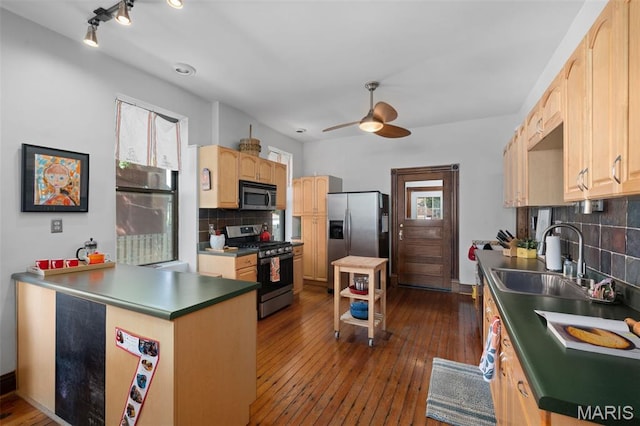 6505 Michigan Ave, Saint Louis, MO 63111 - kitchen with appliances with stainless steel finishes, ceiling fan, tasteful backsplash, light brown cabinetry, and a peninsula