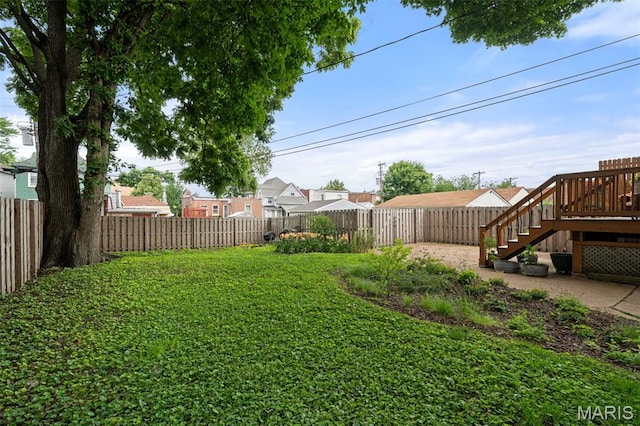 6505 Michigan Ave, Saint Louis, MO 63111 - fenced backyard featuring stairs, a residential view, a patio area, and a deck