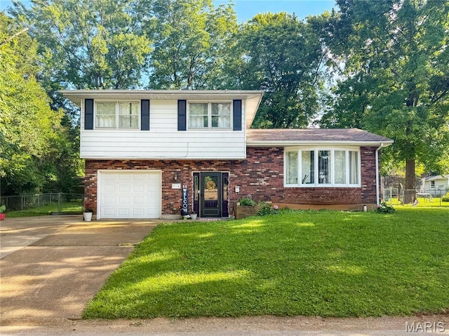 914 Ruby Dr, Farmington, MO 63640 - split level home with concrete driveway, a garage, and brick siding