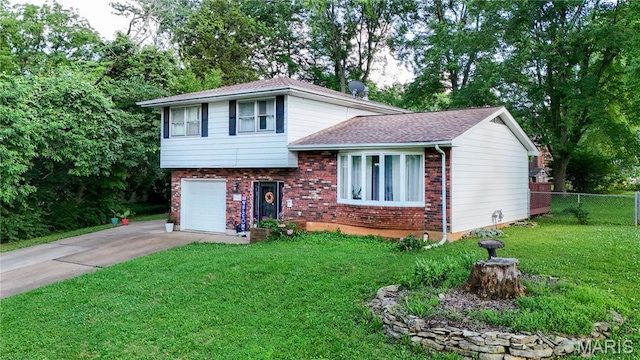 914 Ruby Dr, Farmington, MO 63640 - tri-level home with brick siding, concrete driveway, a garage, a shingled roof, and view of scattered trees