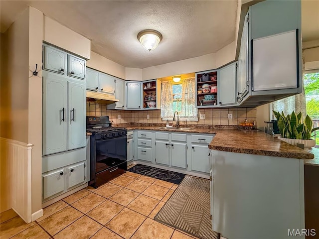 914 Ruby Dr, Farmington, MO 63640 - kitchen with gas stove, dark countertops, open shelves, custom range hood, and tasteful backsplash