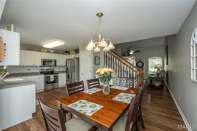 7202 Geneva Manor Ct, Oakville Township, MO 63129 - dining space with stairs, dark wood-style floors, a chandelier, and a ceiling fan