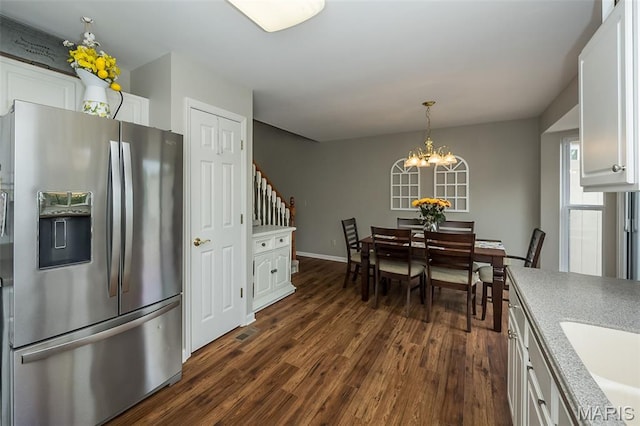 7202 Geneva Manor Ct, Oakville Township, MO 63129 - dining space with dark wood-type flooring and a chandelier