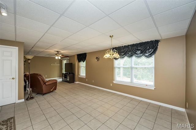 7202 Geneva Manor Ct, Oakville Township, MO 63129 - unfurnished living room featuring a paneled ceiling, light tile patterned floors, a chandelier, and ceiling fan