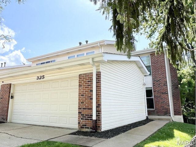 325 Fox Village Ct, Ballwin, MO 63021 - view of property exterior with brick siding and a garage