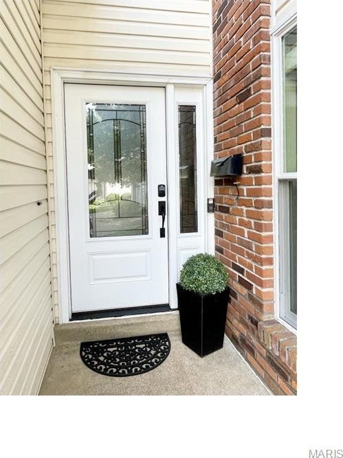 325 Fox Village Ct, Ballwin, MO 63021 - view of exterior entry featuring brick siding