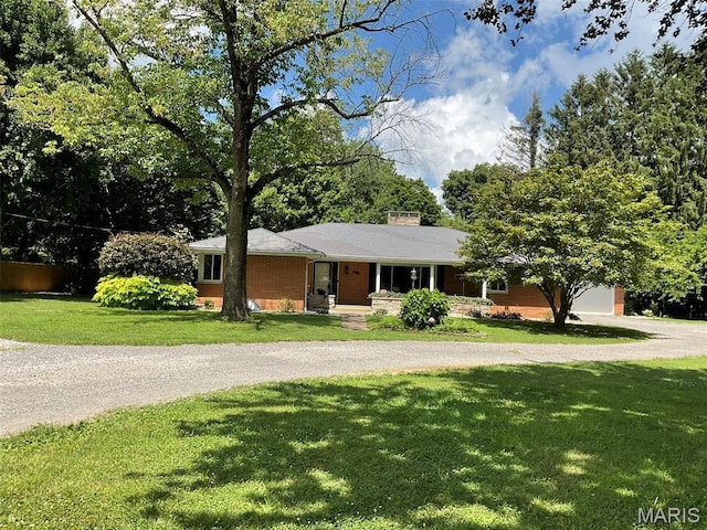 4303 State Route 160, Highland, IL 62249 - single story home featuring curved driveway, a front lawn, a chimney, and a garage