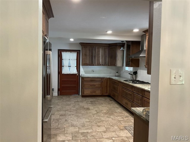 4303 State Route 160, Highland, IL 62249 - kitchen featuring wall chimney exhaust hood, stainless steel appliances, stone finish floors, recessed lighting, and decorative backsplash