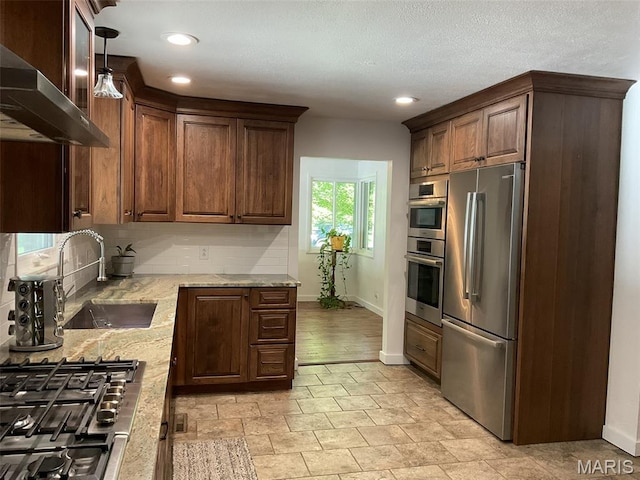 4303 State Route 160, Highland, IL 62249 - kitchen with appliances with stainless steel finishes, range hood, light stone countertops, tasteful backsplash, and recessed lighting