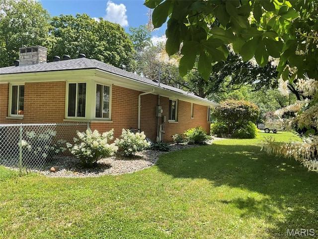 4303 State Route 160, Highland, IL 62249 - view of home's exterior featuring brick siding, a yard, and a chimney