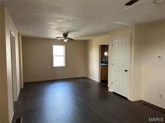 2008 Grace St, Hannibal, MO 63401 - spare room with ceiling fan, a textured ceiling, and dark wood-style flooring