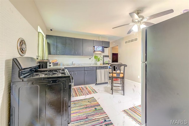 1755 Atmore Dr, Saint Louis, MO 63136 - kitchen with stainless steel appliances, gray cabinets, a ceiling fan, and light countertops