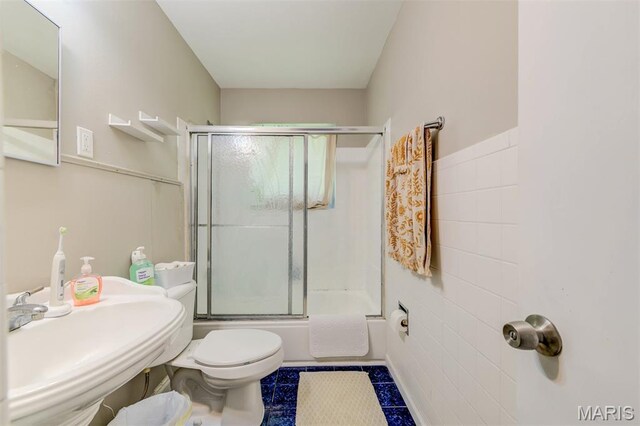 1755 Atmore Dr, Saint Louis, MO 63136 - bathroom featuring shower / bath combination with glass door and tile walls