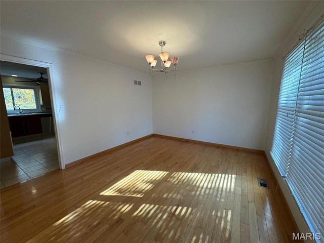12383 Woodline Dr, Saint Louis, MO 63141 - spare room with a chandelier, wood-type flooring, and crown molding