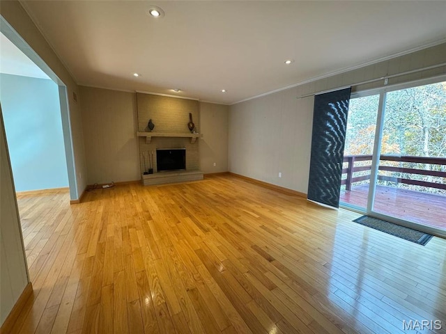 12383 Woodline Dr, Saint Louis, MO 63141 - unfurnished living room featuring light wood-type flooring, ornamental molding, a brick fireplace, and recessed lighting