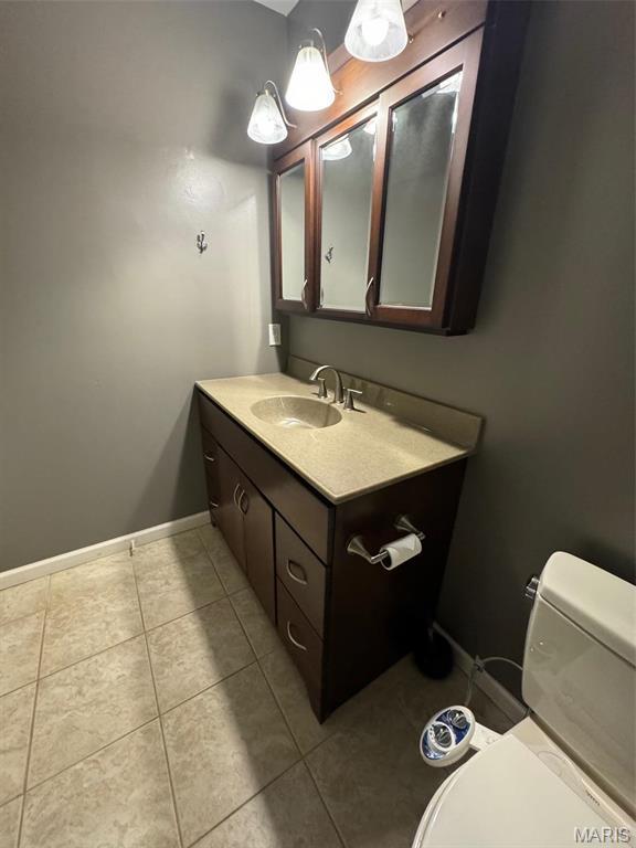 12383 Woodline Dr, Saint Louis, MO 63141 - half bath with vanity and tile patterned floors
