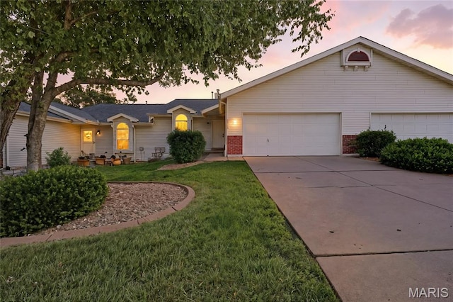 1516 Lienemann Dr Unit 26, Saint Charles, MO 63303 - single story home featuring a garage, concrete driveway, brick siding, and a front lawn
