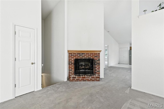 1516 Lienemann Dr Unit 26, Saint Charles, MO 63303 - unfurnished living room with carpet floors, a brick fireplace, and high vaulted ceiling