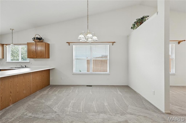 1516 Lienemann Dr Unit 26, Saint Charles, MO 63303 - unfurnished dining area with vaulted ceiling, light colored carpet, and a chandelier