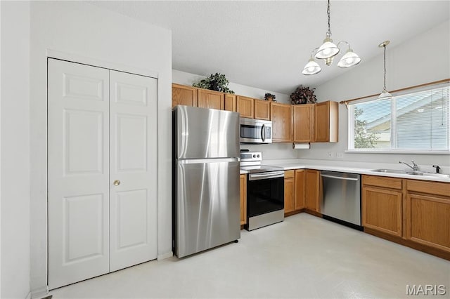 1516 Lienemann Dr Unit 26, Saint Charles, MO 63303 - kitchen featuring appliances with stainless steel finishes, hanging light fixtures, light countertops, a chandelier, and brown cabinetry