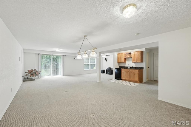 1516 Lienemann Dr Unit 26, Saint Charles, MO 63303 - unfurnished living room with bar with sink, light carpet, and a textured ceiling