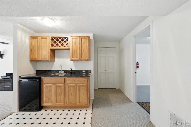 1516 Lienemann Dr Unit 26, Saint Charles, MO 63303 - kitchen with black dishwasher, dark countertops, and light colored carpet