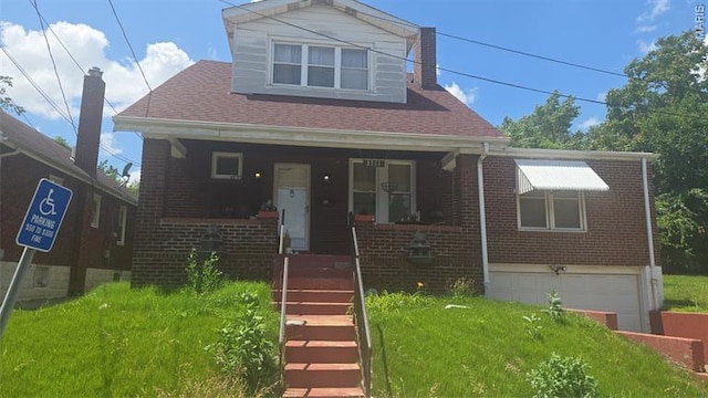 3711 Lawler Dr, Saint Louis, MO 63121 - bungalow-style home with brick siding, covered porch, a garage, and roof with shingles