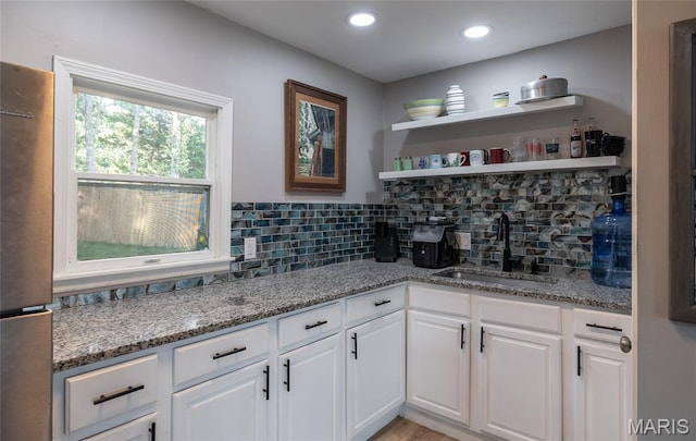 77 Indian Hills Dr, Cuba, MO 65453 - kitchen featuring freestanding refrigerator, white cabinetry, backsplash, light stone countertops, and recessed lighting