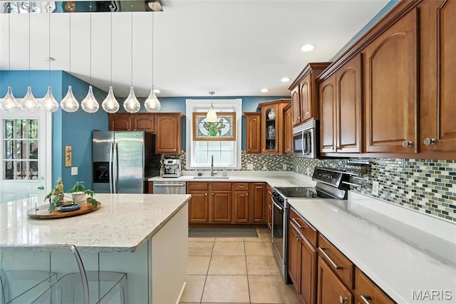 2812 Indiana Ave, Saint Louis, MO 63118 - kitchen featuring appliances with stainless steel finishes, backsplash, pendant lighting, glass insert cabinets, and recessed lighting