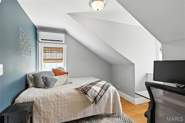 2812 Indiana Ave, Saint Louis, MO 63118 - bedroom with a wall mounted AC, vaulted ceiling, and wood finished floors