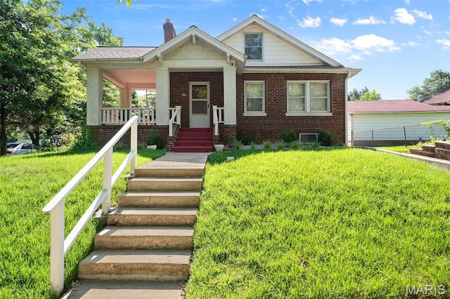 512 N Hills Dr, Saint Louis, MO 63121 - view of front of home with brick siding, a chimney, and a porch