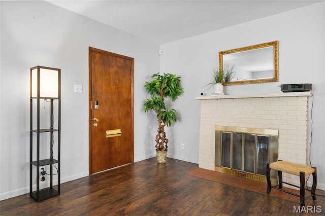 512 N Hills Dr, Saint Louis, MO 63121 - entryway with wood finished floors and a brick fireplace